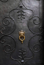 Austria, Salzburg, Old Black Metal Door With Brass Knocker