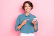 © deagreez - Photo of young pretty adorable cute pretty attractive nice smiling woman finger pointing showing her new smartphone ad app isolated on pink color background