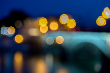 blurred light at night with bokeh in triana bridge seville andalusia spain europe