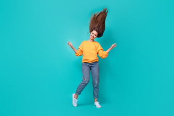 Poster - Full body length photo of young adorable pretty lady wear orange shirt denim jeans hair up strong keratin dancer isolated on aquamarine color background