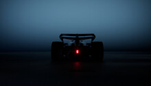 Back View Silhouette Of A Modern Generic Sports Racing Car Standing In A Dark Garage. Realistic 3d Rendering