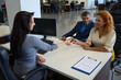 © Svitlana - Woman manager in car dealership passes key to client test drive