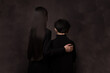 © Milou Dirks - rear view abstract portait of boy and girl, brother and sister, in black in dark studio