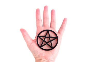 Wall Mural - Large black pentagram resting on a hand palm