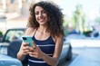 © Krakenimages.com - Young beautiful hispanic woman smiling confident using smartphone at street