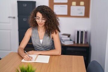 Sticker - Young beautiful hispanic woman business worker writing on notebook working at office