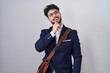 © Krakenimages.com - Hispanic man with beard wearing business clothes with hand on chin thinking about question, pensive expression. smiling and thoughtful face. doubt concept.