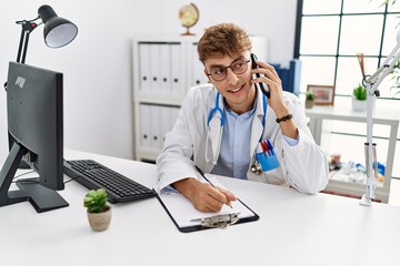 Canvas Print - Young caucasian man wearing doctor uniform working at clinic