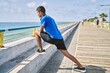 © Krakenimages.com - Young hispanic man stretching leg muscles outdoors
