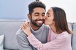 © Krakenimages.com - Man and woman couple hugging each other sitting on sofa at home