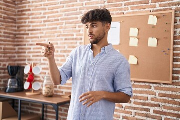 Young arab man business worker smiling confident speaking at office