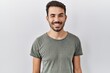 © Krakenimages.com - Young hispanic man with beard wearing casual t shirt over white background winking looking at the camera with sexy expression, cheerful and happy face.