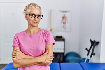 Poster - Middle age blonde woman at pain recovery clinic smiling looking to the side and staring away thinking.