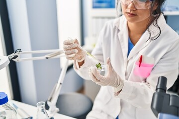 Poster - Young chinese woman wearing scientist uniform working at laboratory