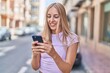 © Krakenimages.com - Young blonde woman smiling confident using smartphone at street
