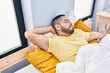 © Krakenimages.com - Young latin man lying on bed sleeping at bedroom