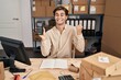 © Krakenimages.com - Young man working at small business ecommerce holding dataphone screaming proud, celebrating victory and success very excited with raised arm