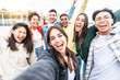 © Davide Angelini - Multiracial friends taking selfie group picture with smart mobile phone outside on city street - Happy young people smiling together looking at camera - Youth lifestyle concept with teens hanging out