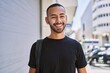 © Krakenimages.com - Young african american man smiling confident wearing backpack at street