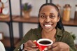 © Krakenimages.com - African american woman smiling confident drinking coffee at home