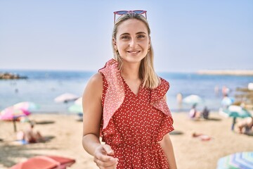 Poster - Young blonde girl smiling happy standing at the beach