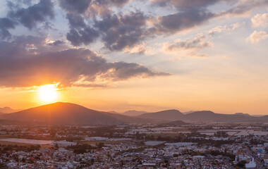 Canvas Print - Aerial: beautiful sunset in the mountains and the city. Drone view