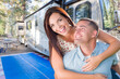 © Andy Dean - Young Adult Military Couple In Front of Their Beautiful RV At The Campground.