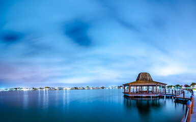 Wall Mural - Panorama gazebo structure by the lagoon at night
