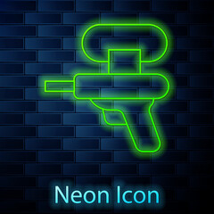 Sticker - Glowing neon line Water gun icon isolated on brick wall background. Vector