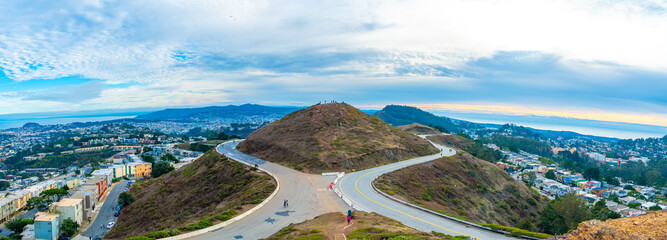 Wall Mural - Epic view of the road in the mountains and cityscape 