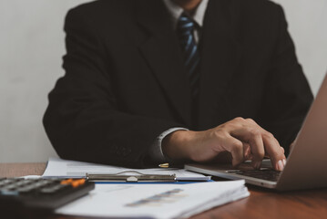 Wall Mural - Business man using computer laptop and paperwork on desk.