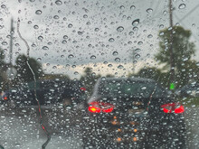 rain drops on the windshield in car traffic 