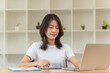 © snowing12 - Lifestyle and technology concept, Young Asian woman writing on tablet and using laptop to working.