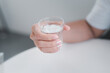 © Chajkrid - hand holding a glass of water