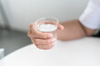 © Chajkrid - person holding glass of water