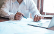 © Naknakhone - Hand businessman signing contract. Asia businessman check the correctness of work at the office with a beautiful pen. Hands working with documents at desk and signing contract.Deal concept.