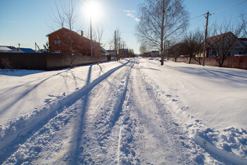 Wall Mural - Road in the snow in winter as a background.