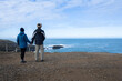 © Janice - Couple standing at the Slope Point, southernmost point of South Island, New Zealand.