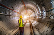 © sornchai - Soft focus and blurred lighting background of focus at engineer or technician control. Underground tunnel infrastructure. Transport pipeline by Tunnel Boring Machine for electric train subway