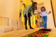 Therapist helping a young child living with cerebral palsy successfully improve her walking ability using texture walk.