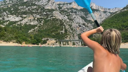 Wall Mural - Young boy canoeing in river ( kayak, canoe in France, verdon)