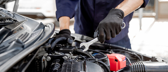 Car care maintenance and servicing, Close-up hand technician auto mechanic using the wrench to repairing change spare part car engine problem and insurance service support.