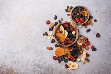 Wall Mural - Wooden bowls with raisins, nuts and other dried fruit, berries as ingredient for tasty dessert