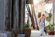 Caucasian blonde woman walking on the street of the old town with a long dress