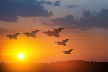 Wall Mural - Air Force Day. Aircraft silhouettes on background of sunset or sunrise.