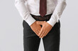 © Pixel-Shot - Businessman with prostate problem on light background