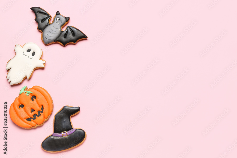 Tasty Halloween cookies on pink background