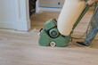 © ungvar - Process of grinding wooden parquet floor with floor sander in new house when it has just been constructed