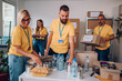 © Zamrznuti tonovi - Group of volunteers working in community charity donation center