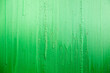 green background - the surface painted with green paint - the surface is not even, covered with paint, a lot of dried dripping drops, part of the surface is faded